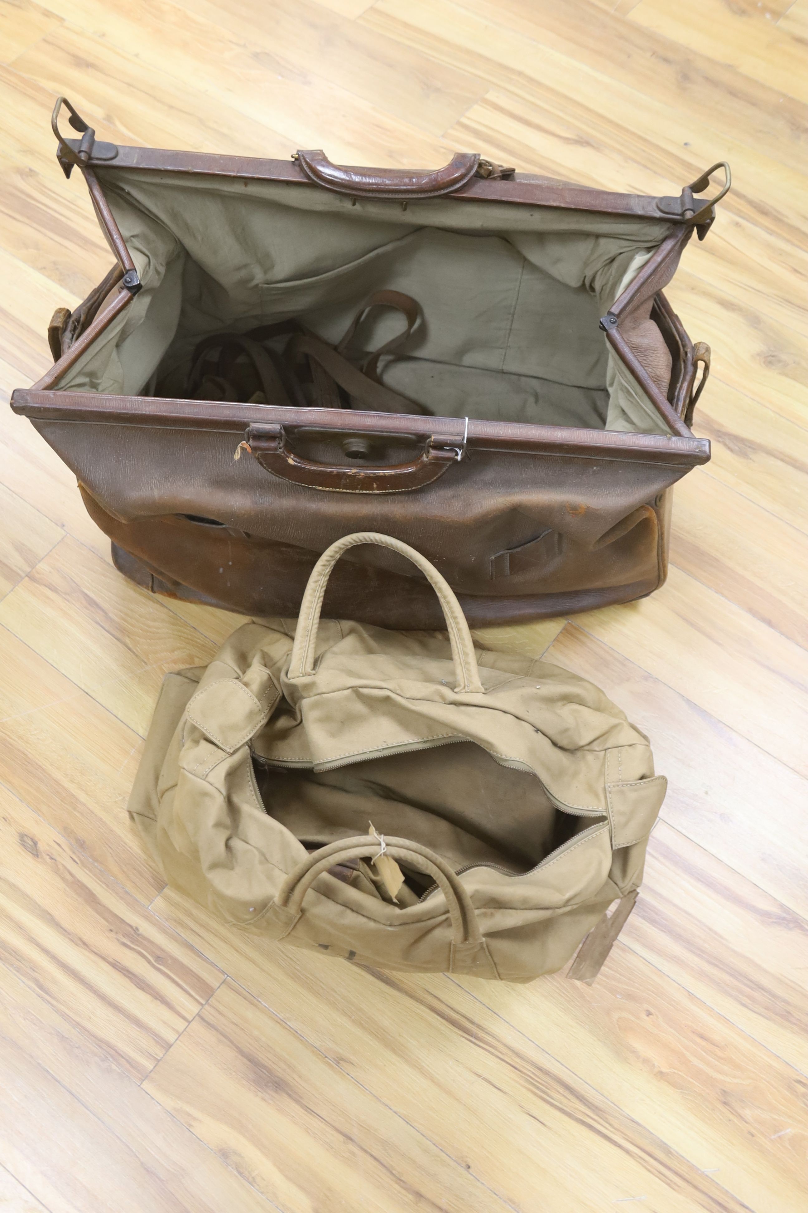 A large Gladstone bag, military canvas contents